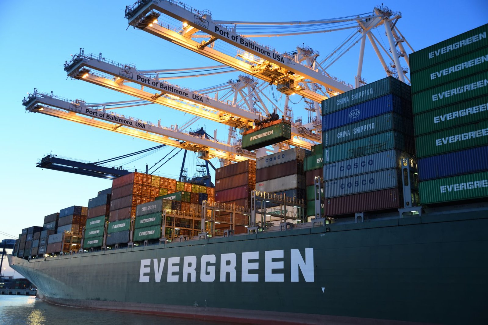 Cargo vessel in industrial port environment — illustrative